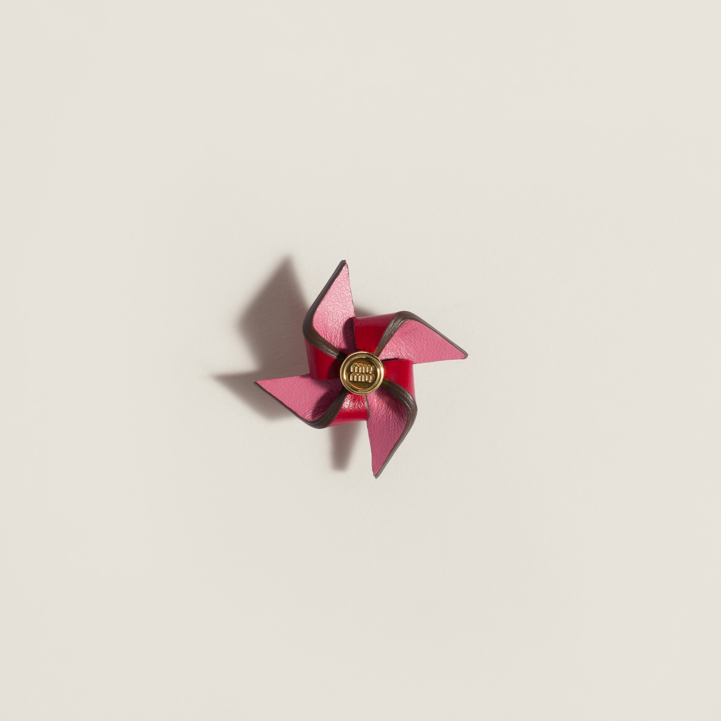 Leather pinwheel brooch from Miu Miu - $260