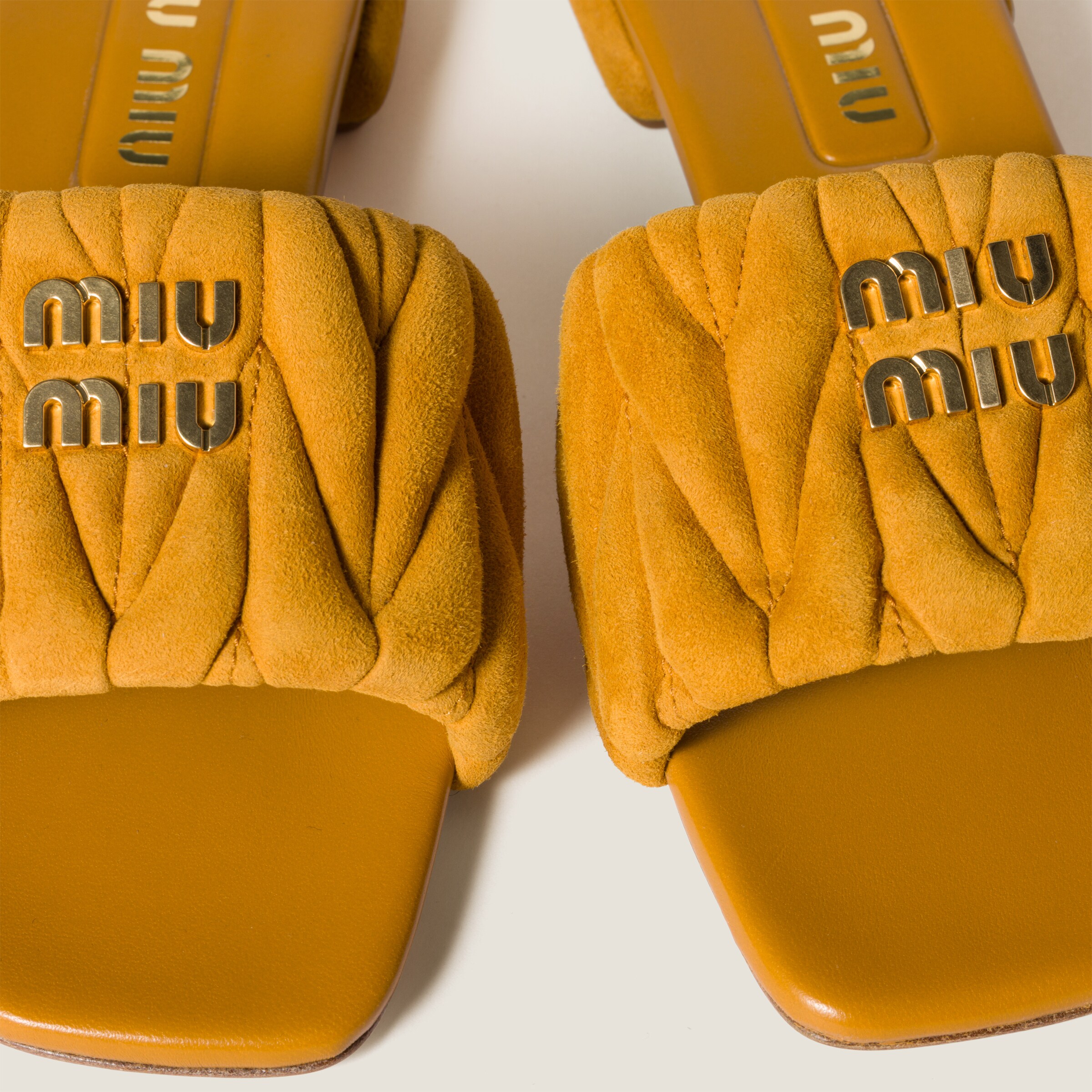 MIU MIU MATELASSÉ SUEDE SLIDES